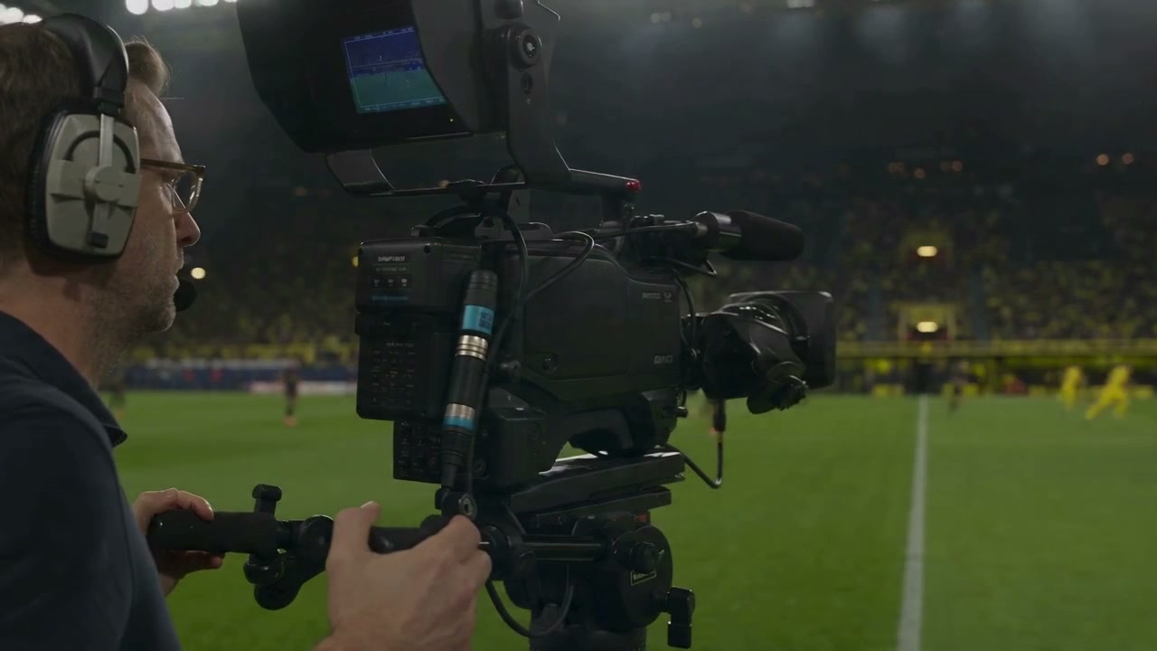 Camera operator at a stadium during a live broadcast